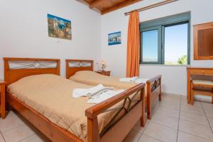 A bed or beds in a room at Spiros Villas Collection