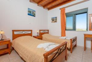A bed or beds in a room at Spiros Villas Collection