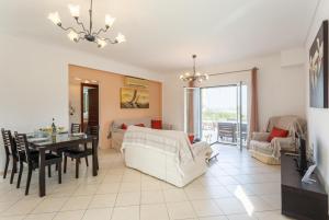 a living room with a table and a dining room at Villa Europe Ena in Lakithra