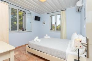 Posteľ alebo postele v izbe v ubytovaní Maria Beach House