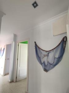 a hammock hanging on a wall in a room at Ático en Barbate in Barbate
