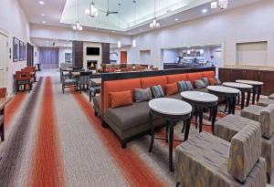 a restaurant with couches and tables and a bar at Homewood Suites Laredo at Mall Del Norte in Laredo