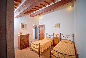 two beds in a room with white walls at Casale Donatelli in Radicofani +66 photos