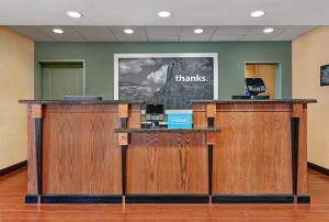 a lobby with two wooden counters with the wordsthanks at Hampton Inn Lordsburg in Lordsburg
