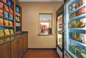 a grocery store aisle with a refrigerator and food at Hampton Inn Lordsburg in Lordsburg