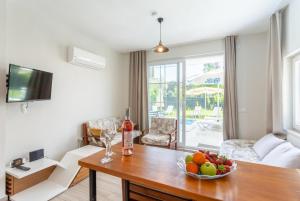 a living room with a table with a bowl of fruit on it at Villa Zonkdemir in Dalyan