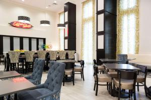 un restaurante con mesas y sillas y un bar en Hampton Inn and Suites La Crosse Downtown, en La Crosse