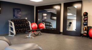 a gym with red dumbbells on the wall at Hampton Inn and Suites La Crosse Downtown in La Crosse