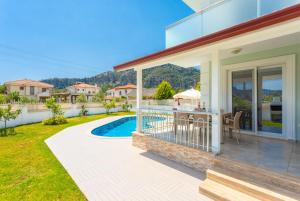 a house with a patio and a swimming pool at Villa Veli in Dalyan