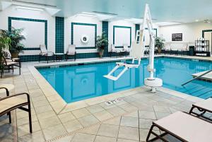 a pool at a hotel with tables and chairs at Hampton Inn Littleton in Littleton