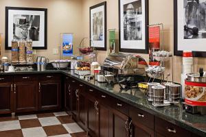 a kitchen with a counter with food on it at Hampton Inn Littleton in Littleton