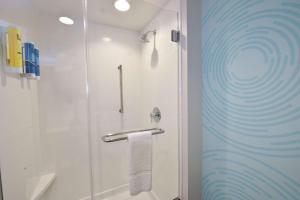 a bathroom with a shower with a glass door at Tru By Hilton Lawrence in Lawrence