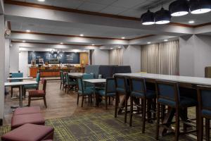 a restaurant with tables and chairs and a counter at Hampton Inn Gretna - Smith Mountain Lake in Gretna