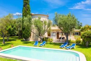 a villa with a swimming pool in front of a house at Villa La Torre in Alcudia