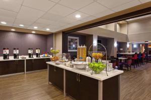 a lobby with a counter with bowls of fruit on it at Hampton Inn and Suites Merced in Merced