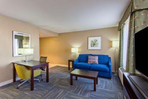 a living room with a blue couch and a table at Hampton Inn and Suites Merced in Merced