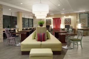 a chair in a lobby with tables and chairs at Home2 Suites By Hilton Leavenworth Downtown in Leavenworth