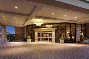 an empty lobby of a building with a chandelier at DoubleTree by Hilton McLean Tysons in Tysons Corner