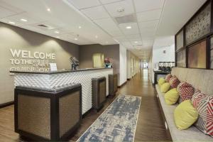 a lobby with a waiting area with couches and a bar at Hampton Inn & Suites Orlando-Apopka in Orlando