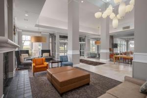 a living room with a couch and chairs at Hilton Garden Inn Overland Park in Overland Park
