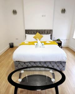 a bedroom with a bed with a table in front of it at The Private Rooms in Paddington in London