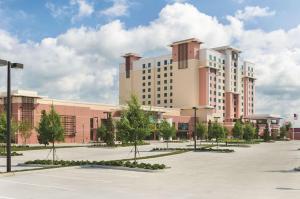 un grande edificio con un parcheggio di fronte di Embassy Suites by Hilton Orlando Lake Buena Vista South a Kissimmee