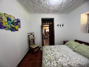 a bedroom with a bed and a ceiling at casona torremolinos in Moniquirá