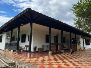 a white house with a black roof at casona torremolinos in Moniquirá