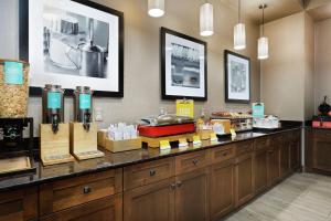 a kitchen with a counter with food on it at Hampton Inn & Suites Orlando/Downtown South - Medical Center in Orlando