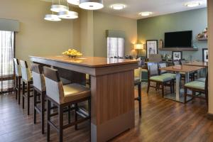 a bar in a room with chairs and tables at Hampton Inn Closest to Universal Orlando in Orlando