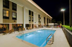 a swimming pool in front of a building at night at Hampton Inn Mount Dora in Mount Dora