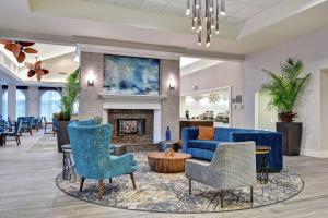 a lobby with blue furniture and a fireplace at Homewood Suites by Hilton Lake Buena Vista - Orlando in Orlando