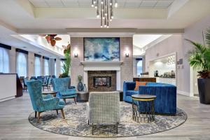 a lobby with blue chairs and a fireplace at Homewood Suites by Hilton Lake Buena Vista - Orlando in Orlando