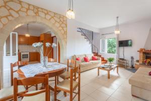 a kitchen and living room with a table and chairs at Kalyves Villas Collection in Áyios Andónios