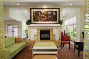 a living room with a couch and a fireplace at Hilton Garden Inn Harrisburg East in Harrisburg