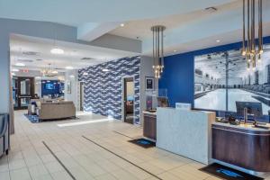 a lobby of a hotel with a reception desk at Scholar State College, Tapestry Collection by Hilton in State College