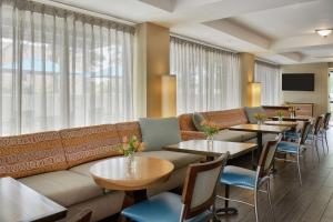 a restaurant with tables and couches and a couch at Hampton Inn Memphis/Collierville in Collierville