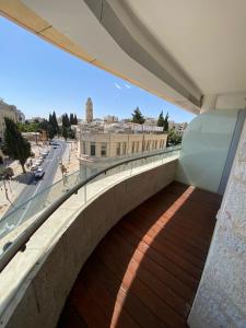 a walkway on a building with a view of a city at David Residence New Private apartment in Jerusalem