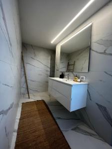 a bathroom with a white sink and a mirror at David Residence New Private apartment in Jerusalem