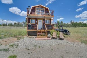 a house that is sitting in a field at Secluded Jefferson Cabin with Deck and Mountain Views! in Bordenville