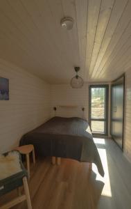 a bedroom with a large bed in a room at Norlight Cottages Ivalo - Aurinko West in Ivalo