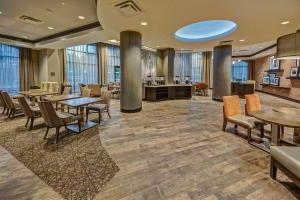 a lobby with tables and chairs and a waiting area at Hampton Inn & Suites Memphis Germantown in Memphis