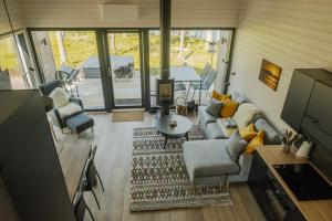 a living room with a couch and chairs and a table at Norlight Cottages Ivalo - Aurinko West in Ivalo