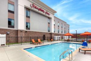 a hotel swimming pool in front of a building at Hampton Inn Wetumpka in Wetumpka
