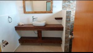 a bathroom with a sink and a mirror at Frenchy's in Providencia