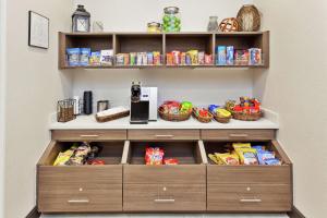 a organized pantry with food and snacks on shelves at Hilton Garden Inn Montgomery - EastChase in Montgomery