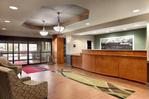 a large lobby with a waiting room with a reception desk at Hampton Inn & Suites by Hilton Manchester Bedford in Bedford