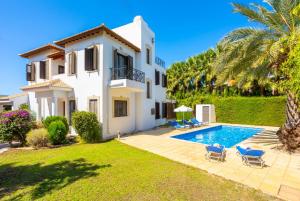 a villa with a swimming pool and a house at Villa Anna in Lachi