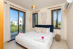 a bedroom with a large bed with towels on it at Villa Anna in Lachi +37 photos