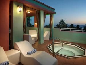 a balcony with a jacuzzi tub on a roof at Hilton Vacation Club Crescent on South Beach Miami in Miami Beach
